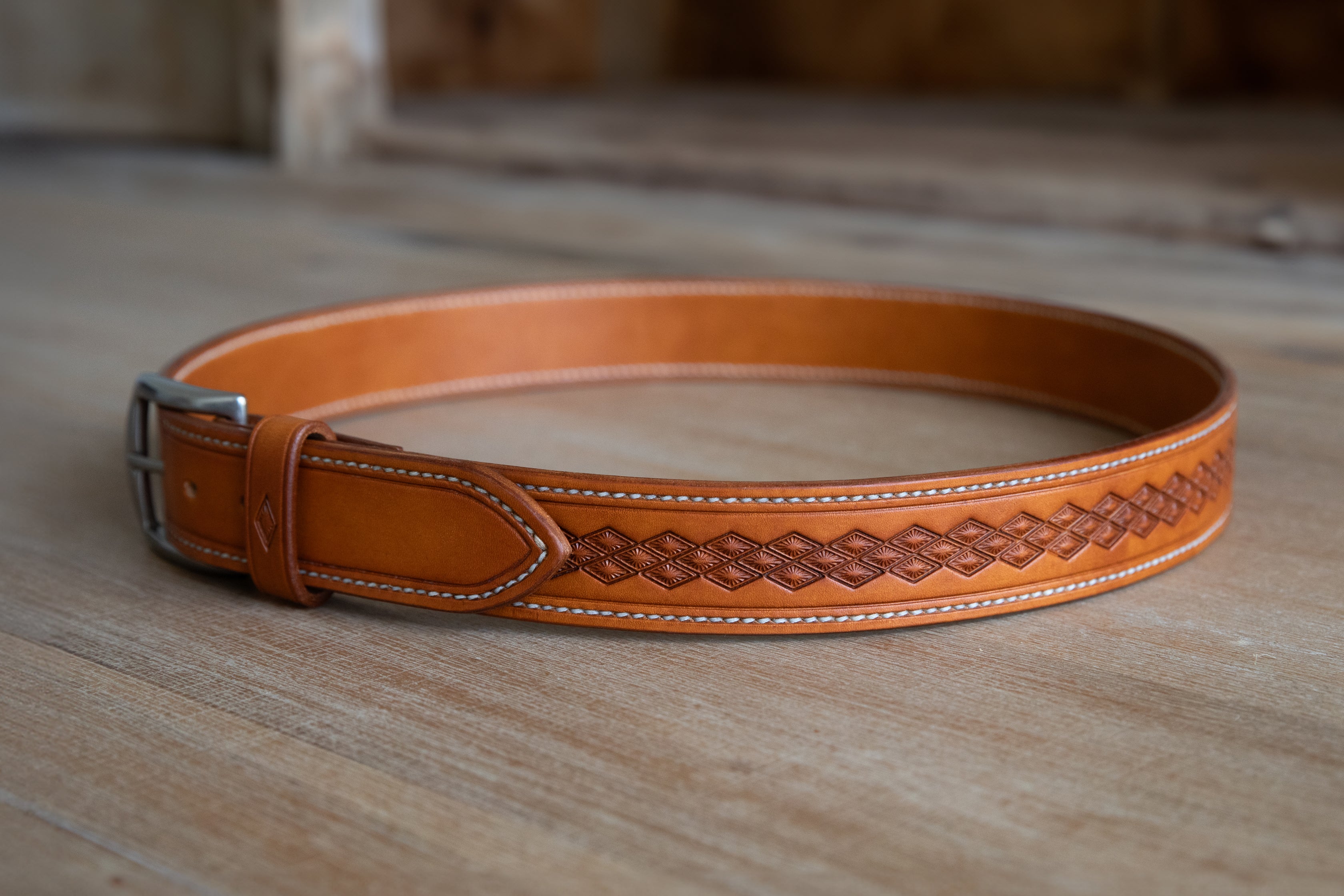 Handmade russet brown leather belt, stitched and embossed by hand. Rustic style with brushed nickle finish solid brass buckle.